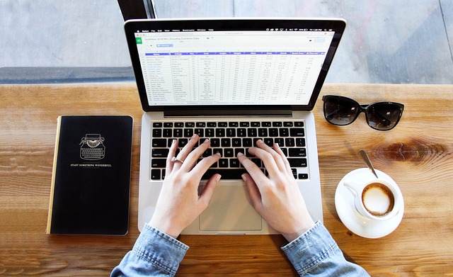 Journalist typing on a laptop