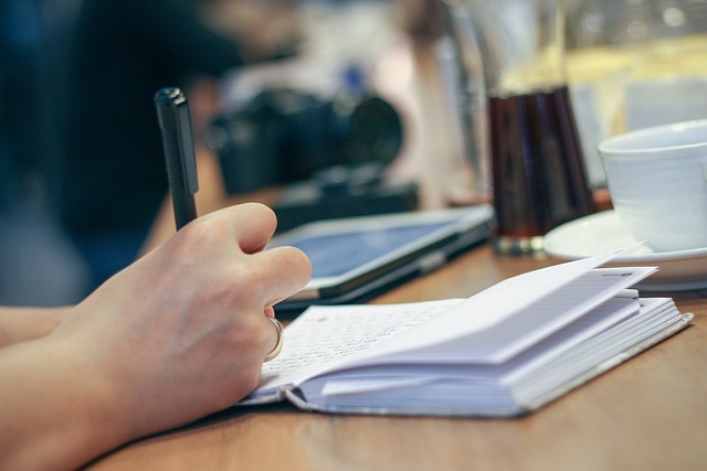 Person writing on a notebook